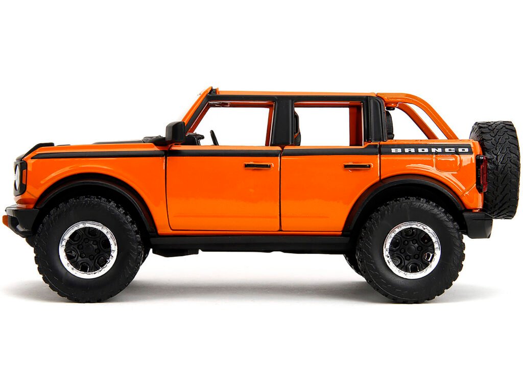 2021 Ford Bronco Open-Top Orange with Black Stripes and Hood with Extra Wheels “Just Trucks” Series 1/24 Diecast Model Car by Jada
